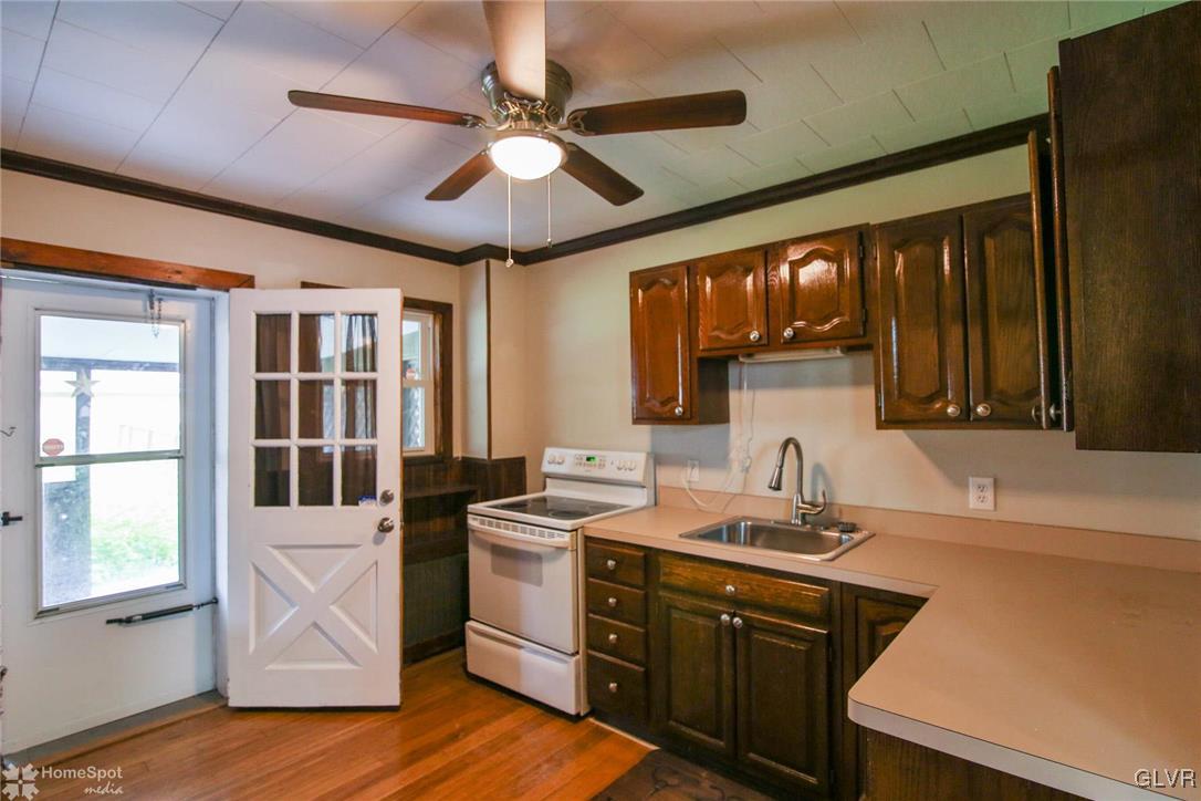 135 Howertown Road Catasauqua, PA 18032 - Photo 3 of 20 a kitchen with a sink cabinets stainless steel appliances and a large window
