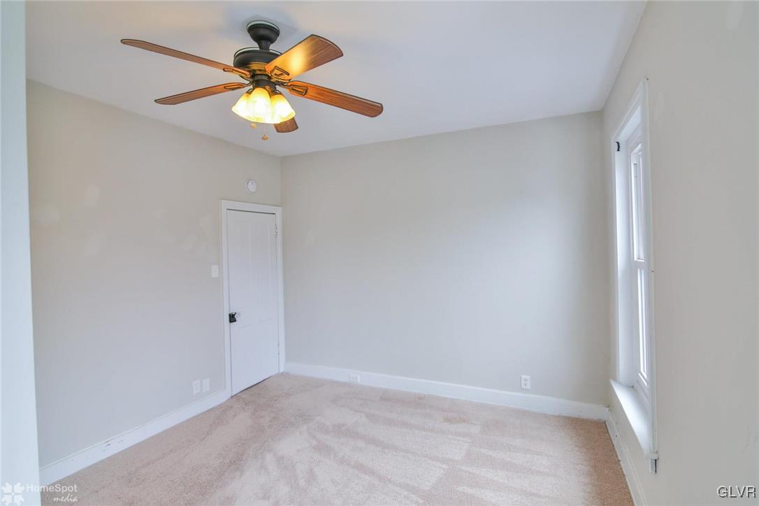 135 Howertown Road Catasauqua, PA 18032 - Photo 9 of 20 an empty room with a chandelier fan and a window