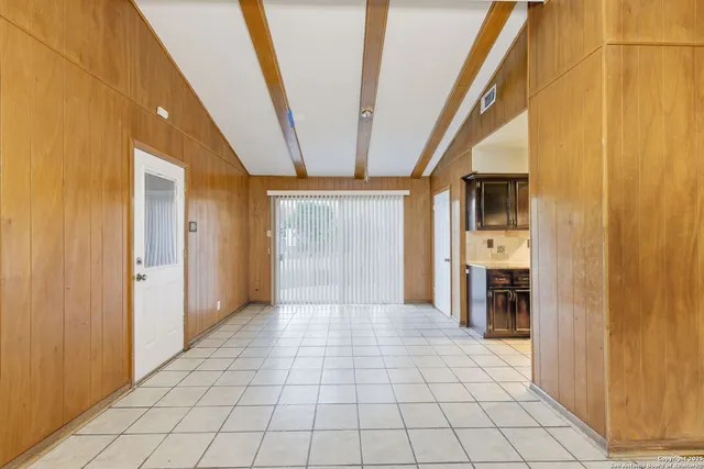 a view of a hallway with chandelier