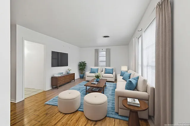 a living room with furniture and a flat screen tv