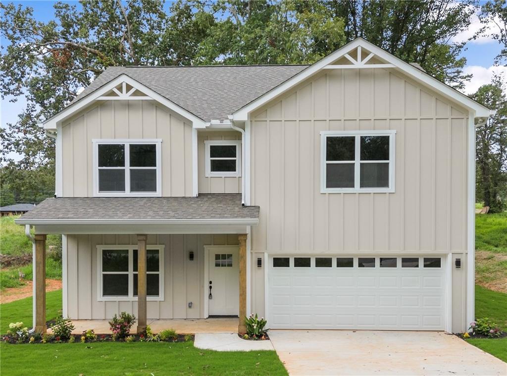 a front view of a house with a yard and garage