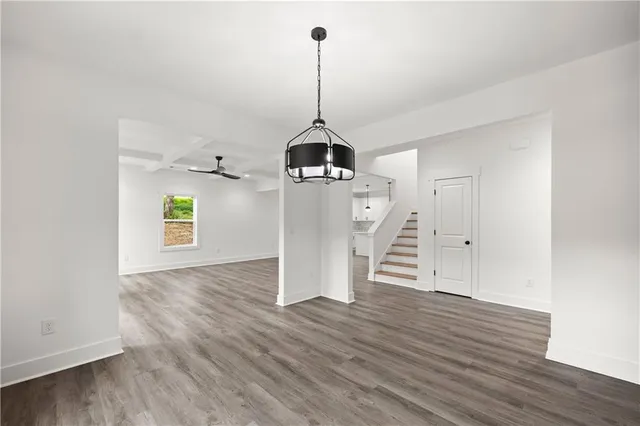 an empty room with closet and windows