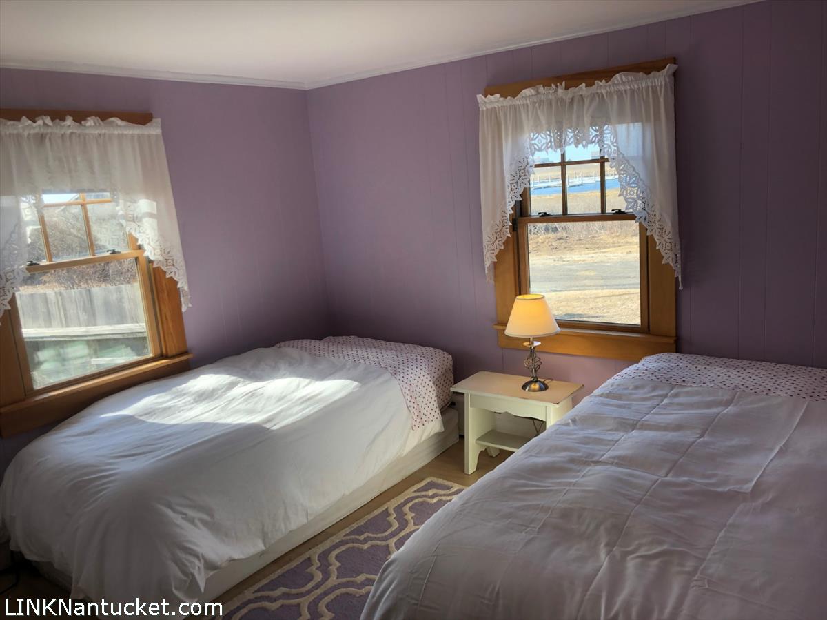 8 M Street Nantucket, MA 02554 - Photo 11 of 20 a bedroom with two beds and next to a window