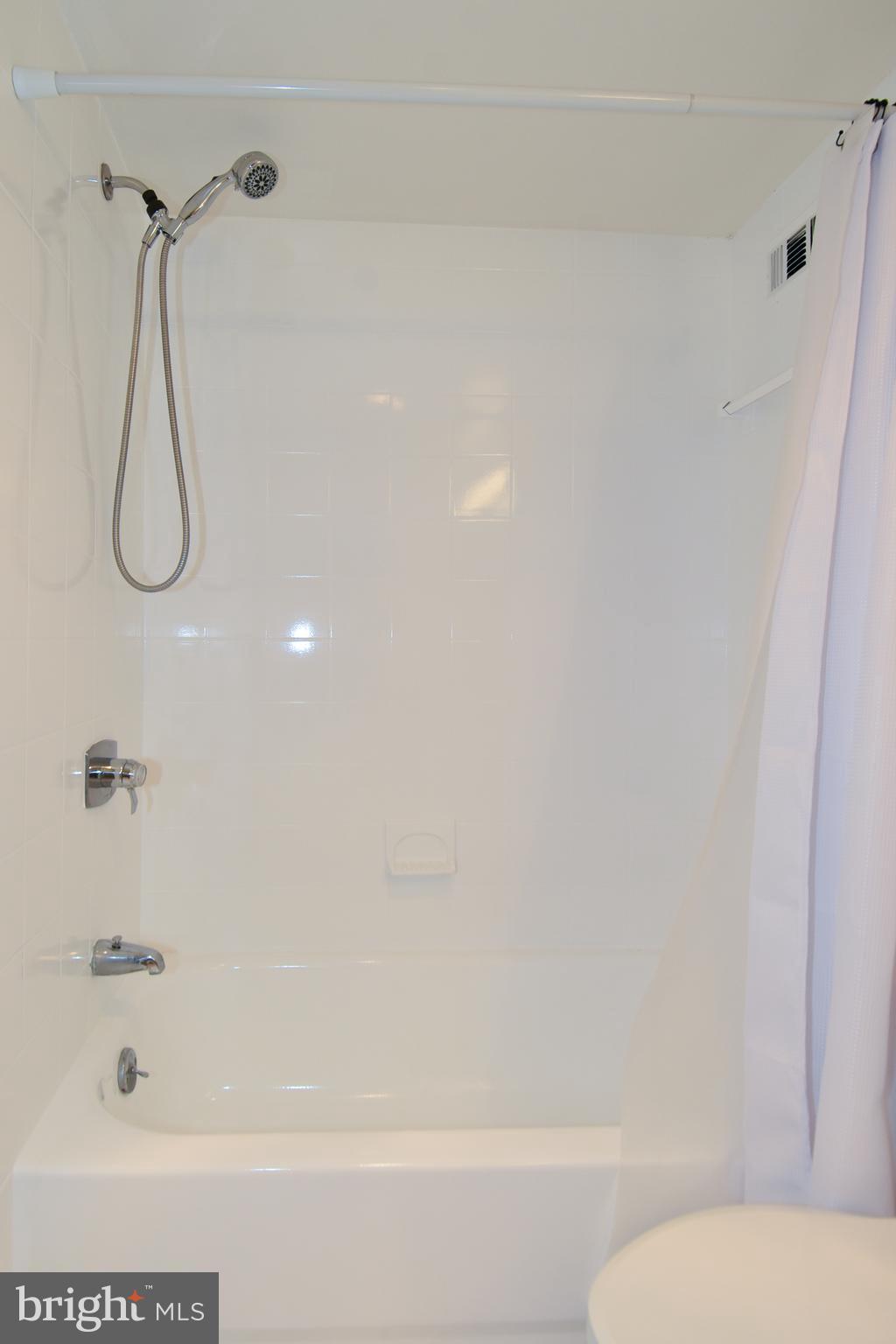 5225 Pooks Hill Road, Unit 1003S Bethesda, MD 20814 - Photo 8 of 30 a bathroom with a bathtub and a shower