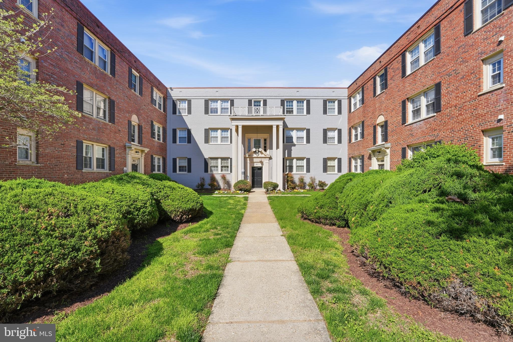 2011 37th Street Southeast, Unit 202 Washington, DC 20020 - Photo 2 of 24 a view of a brick building next to a big yard