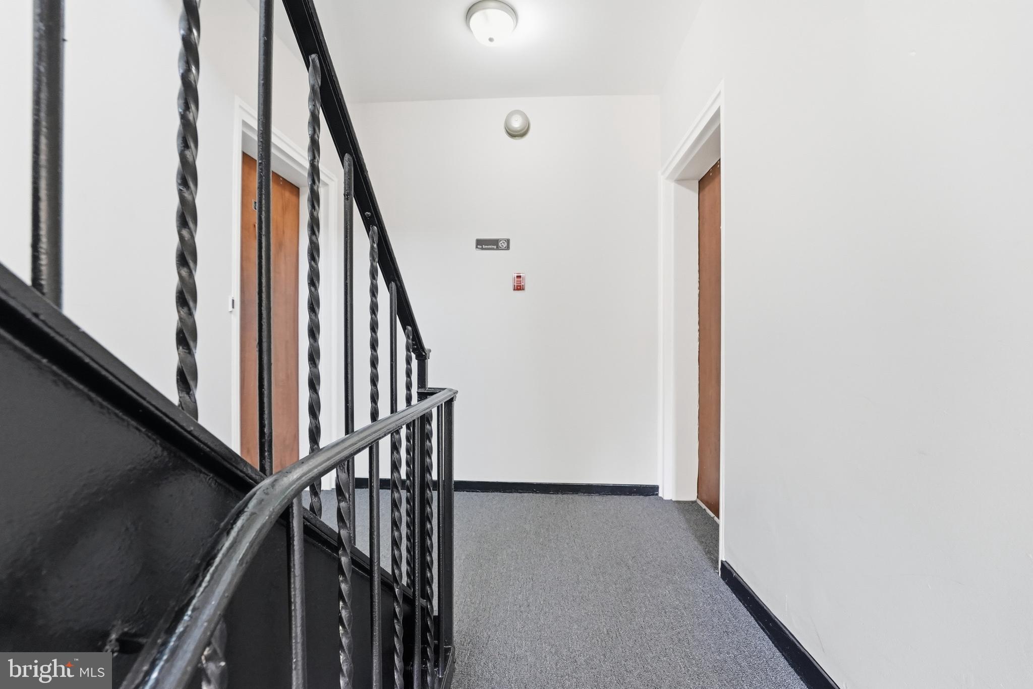 2011 37th Street Southeast, Unit 202 Washington, DC 20020 - Photo 21 of 24 a view of staircase with wooden floor and white walls