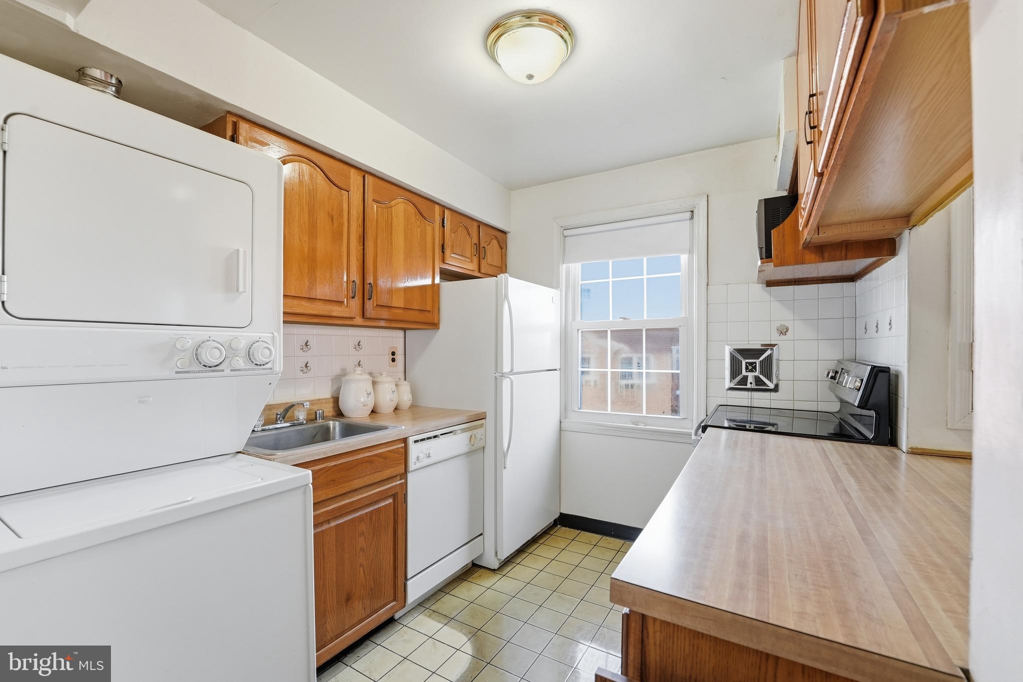 2011 37th Street Southeast, Unit 202 Washington, DC 20020 - Photo 4 of 24 a kitchen with a sink a stove and cabinets
