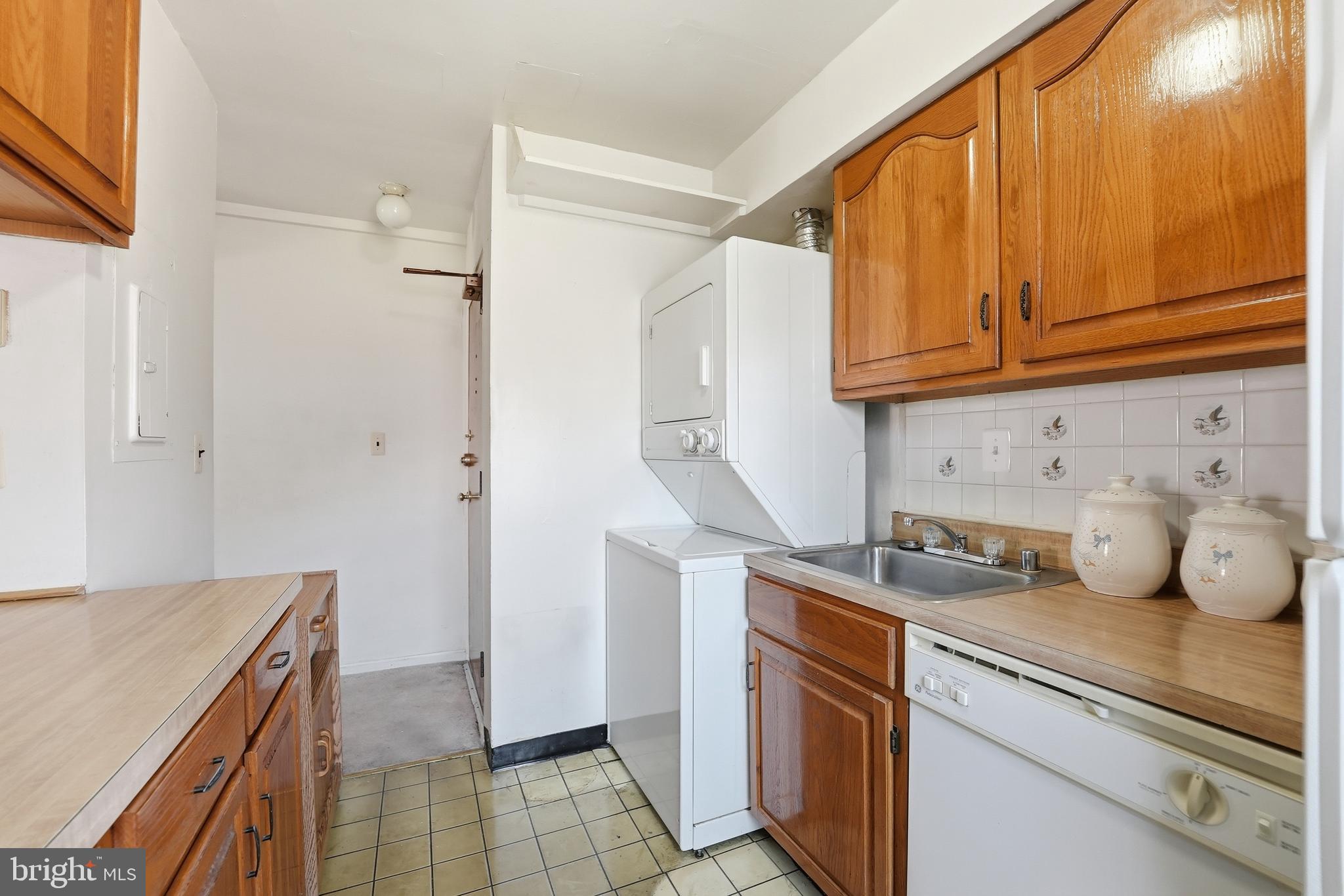 2011 37th Street Southeast, Unit 202 Washington, DC 20020 - Photo 7 of 24 a kitchen with stainless steel appliances granite countertop a sink a stove and a refrigerator
