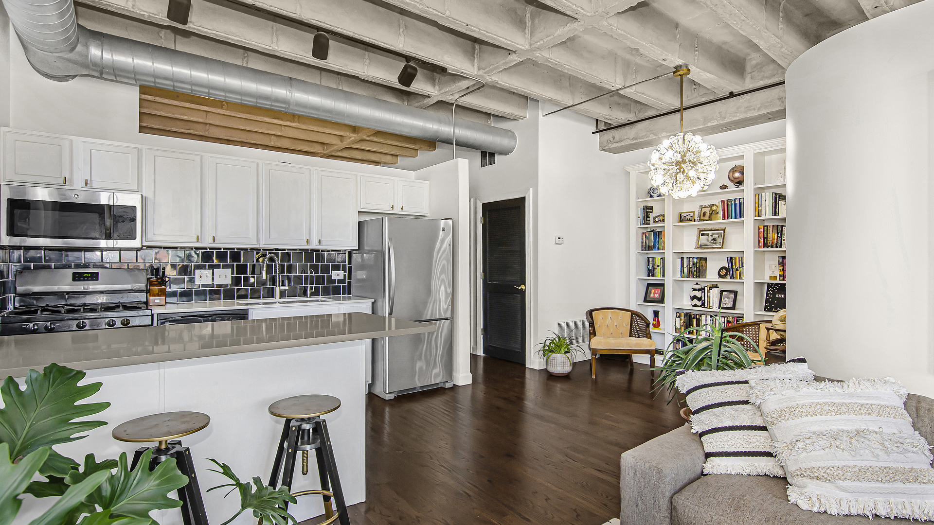 811 South Lytle Street, Unit 508 Chicago, IL 60607 - Photo 8 of 36 a kitchen with stainless steel appliances kitchen island granite countertop a refrigerator and a wooden cabinets