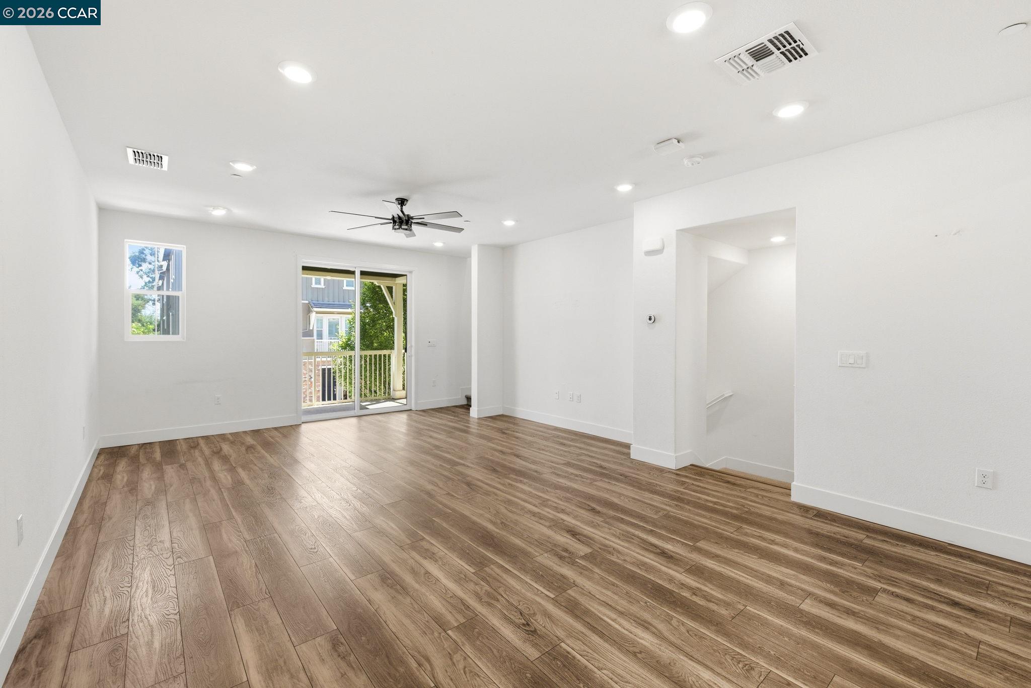 205 Plum Tree Street Livermore, CA 94551 - Photo 26 of 47 an empty room with wooden floor and windows
