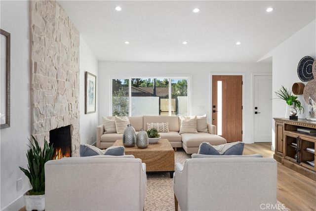 a living room with furniture fireplace and flat screen tv
