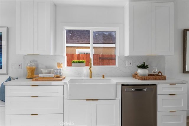 a kitchen with a sink stove and cabinets