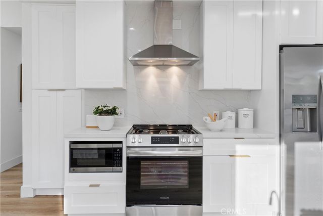 a stove top oven sitting inside of a kitchen
