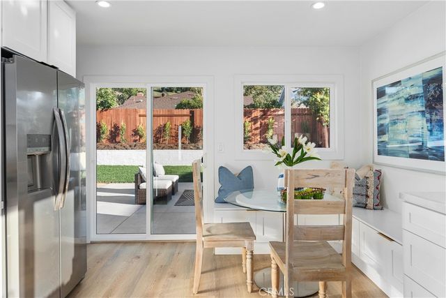 a dining room with furniture and large window