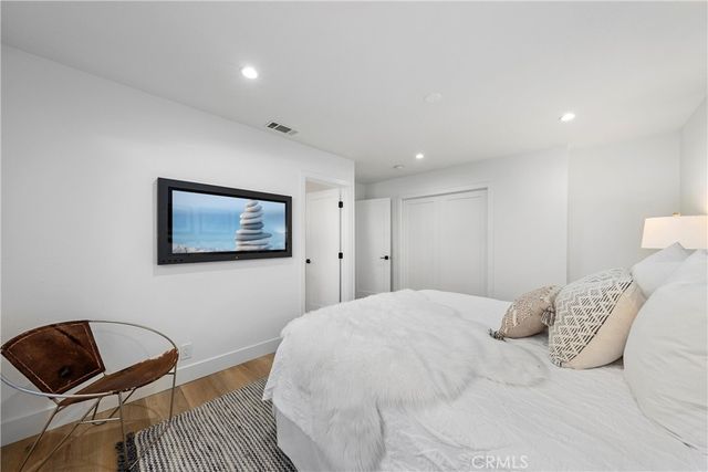 a bedroom with a bed and a chair