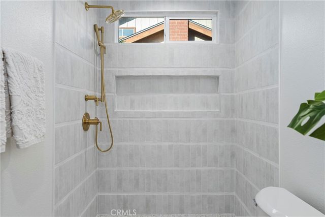 a bathroom with a shower and toilet