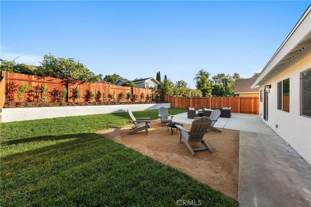 a view of a backyard with sitting area