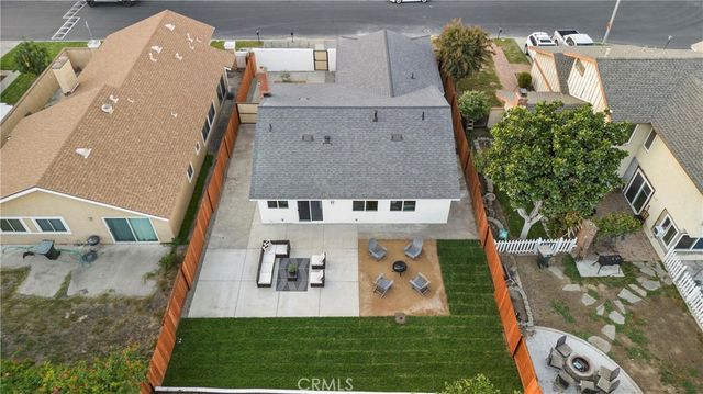 an aerial view of a house with a yard