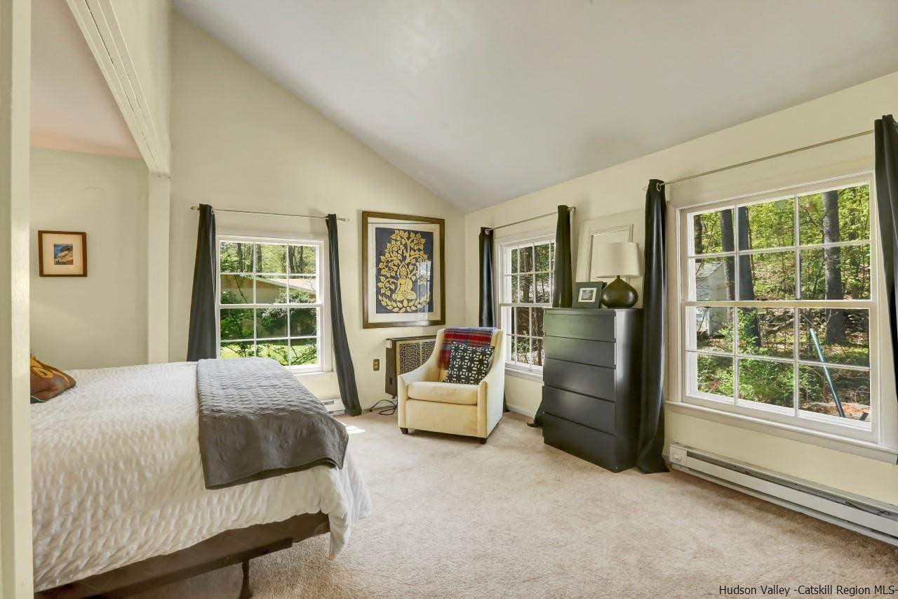 10 Pine Tree Road West Hurley, NY 12491 - Photo 11 of 28 a bedroom with a bed and large windows