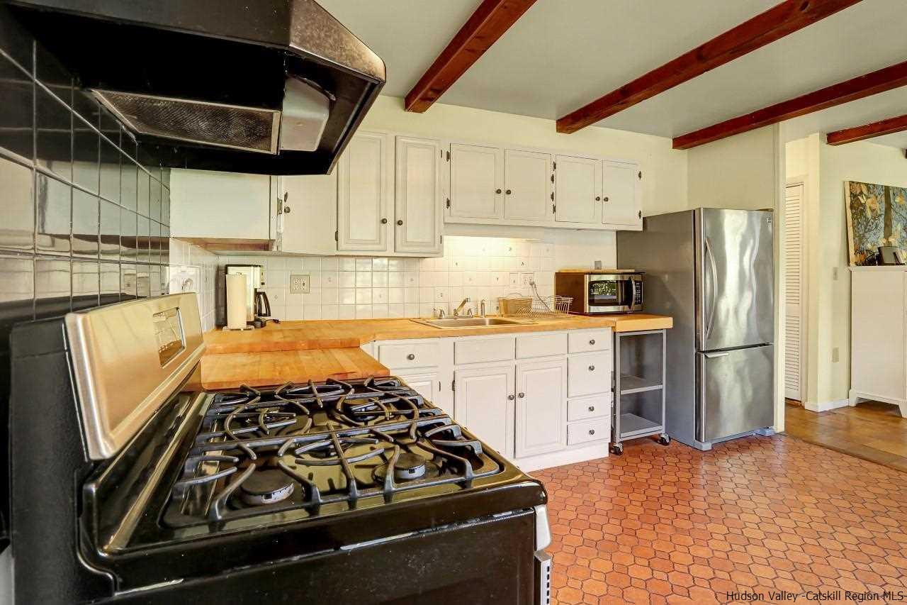 10 Pine Tree Road West Hurley, NY 12491 - Photo 7 of 28 a kitchen with wooden cabinets and a stove top oven