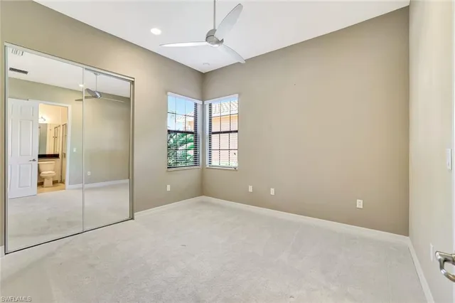 an empty room with windows and entrance