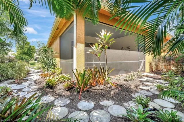 a potted plant is sitting in front of a house
