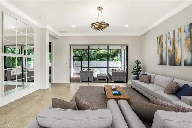a living room with furniture and a chandelier