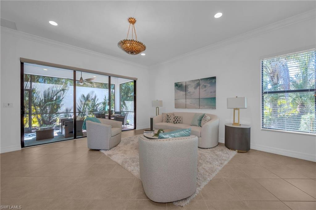 13404 Monticello Boulevard Naples, FL 34109 - Photo 6 of 23 Bright open-concept living area with large windows and seamless indoor-outdoor flow.