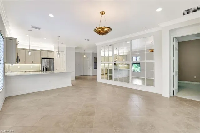 a view of a kitchen with refrigerator and windows