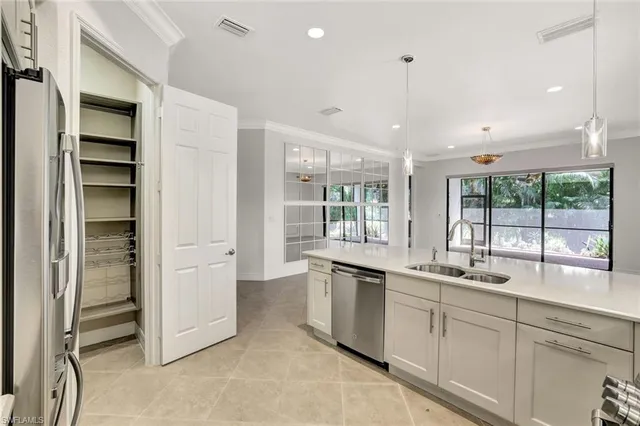 a kitchen with stainless steel appliances granite countertop a sink and a refrigerator