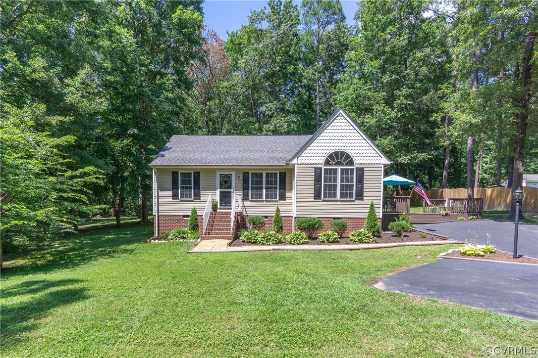 460 Rosebud Run Aylett, VA 23009 - Photo 1 of 32 a front view of a house with a yard table and chairs