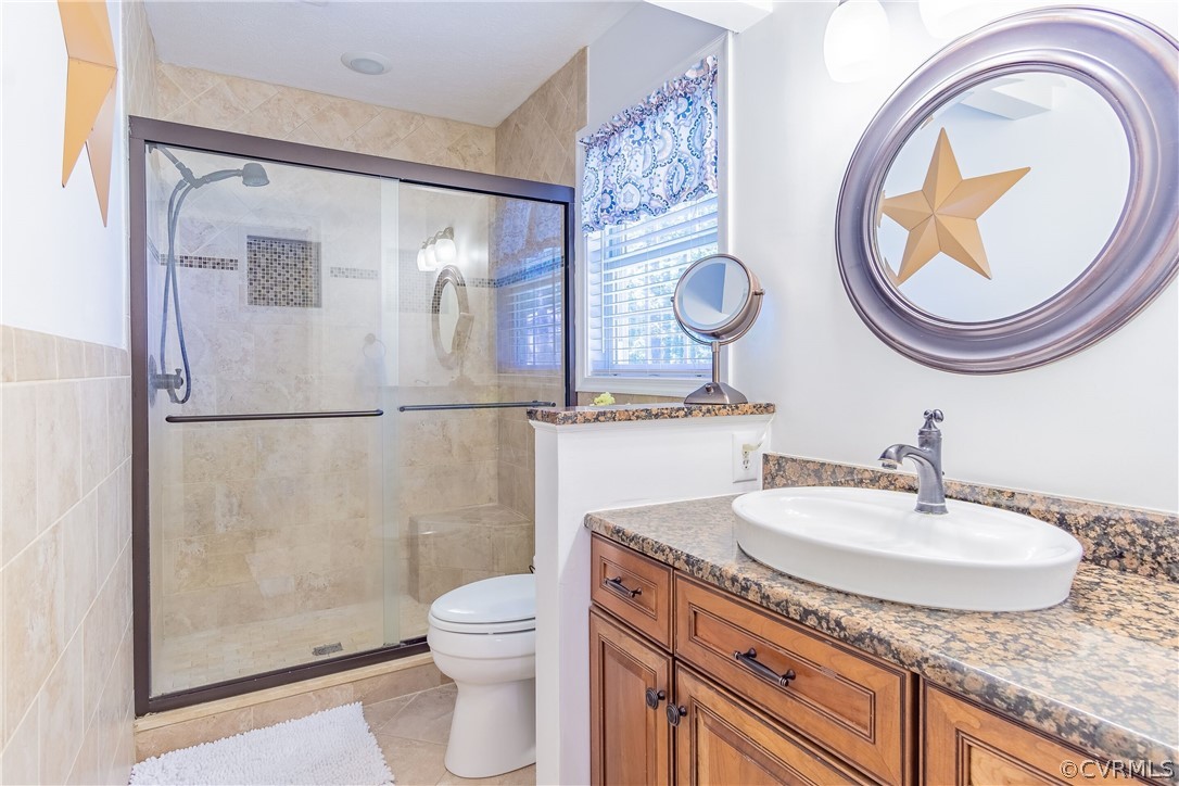 460 Rosebud Run Aylett, VA 23009 - Photo 19 of 32 a bathroom with a granite countertop sink a toilet and a mirror
