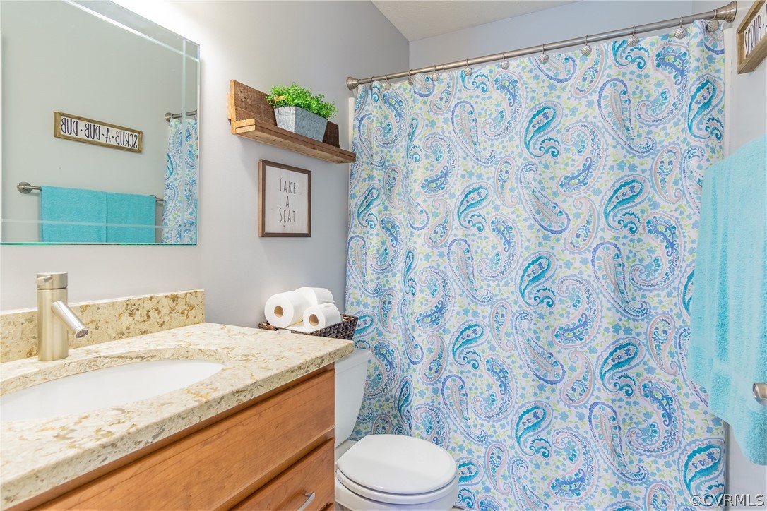 460 Rosebud Run Aylett, VA 23009 - Photo 23 of 32 a bathroom with a granite countertop sink and a toilet