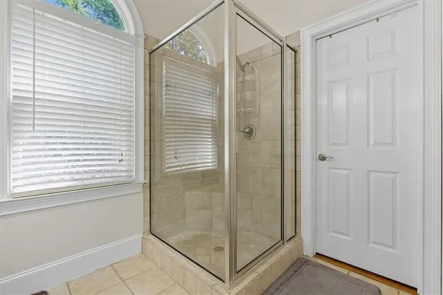 a bathroom with a double vanity sink mirror and shower