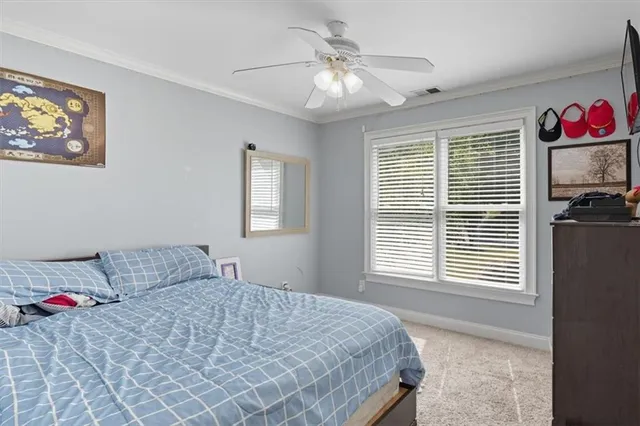 a spacious bedroom with a bed and a window