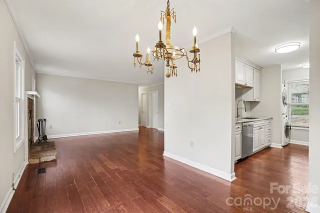 a view of a kitchen with a refrigerator stove cabinets and wooden floor