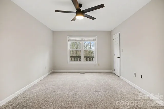 a view of a livingroom with a ceiling fan and window