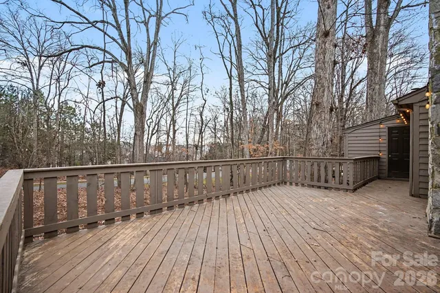 a view of deck with wooden floor and fence and a trees