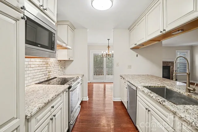 a kitchen with a sink stove and cabinets