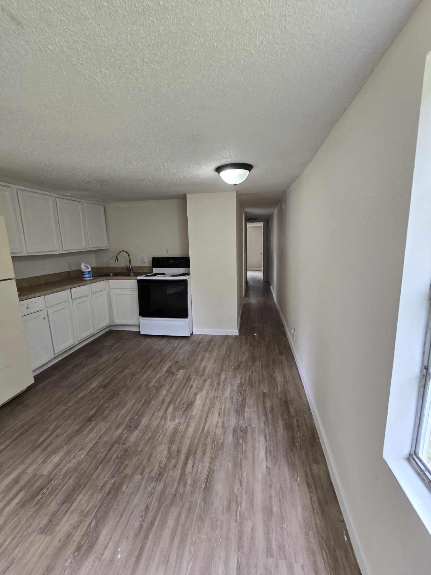 864 East Chestnut Avenue, Unit D Crestview, FL 32539 - Photo 2 of 10 a kitchen with granite countertop a stove and a refrigerator