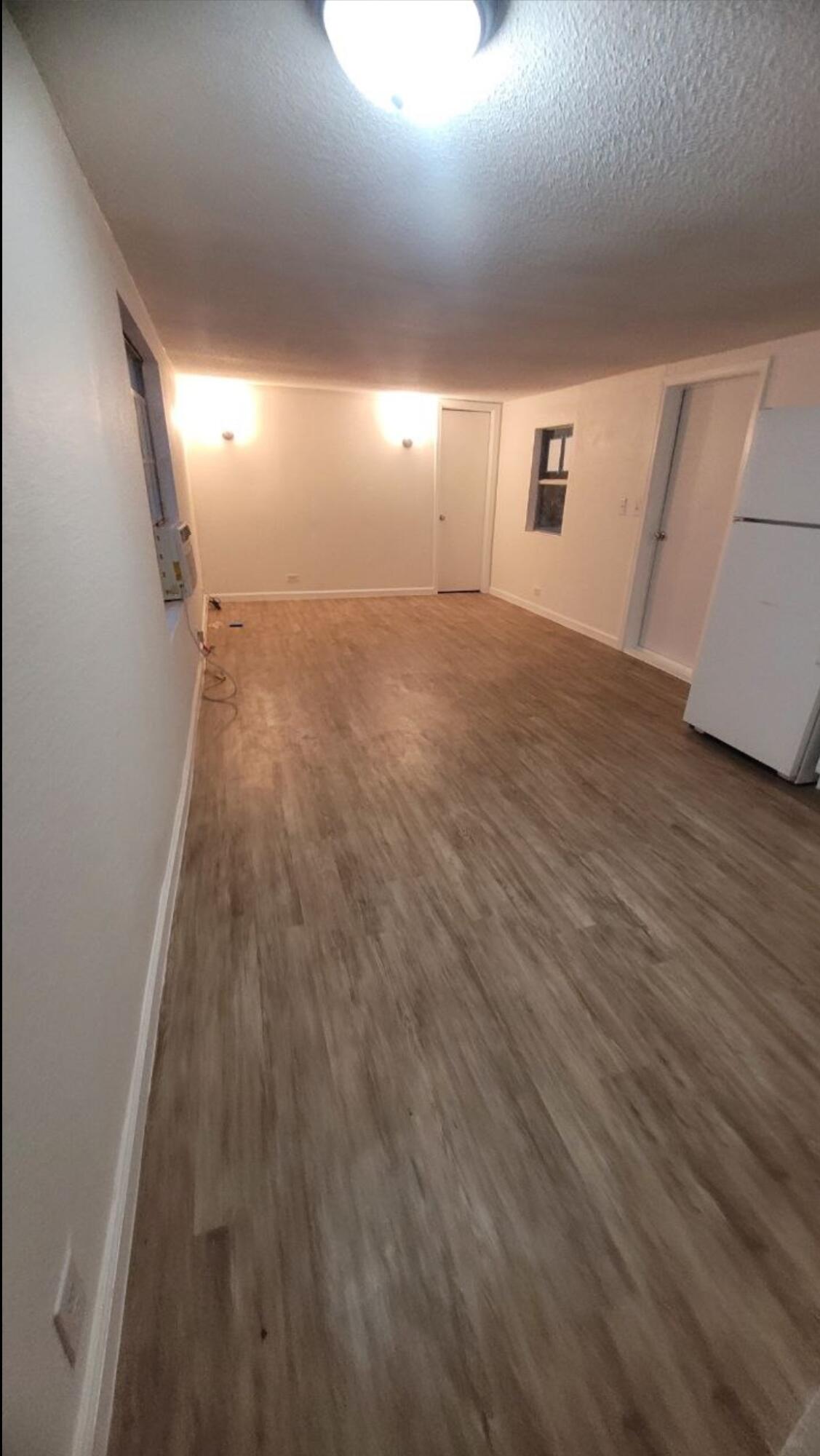 864 East Chestnut Avenue, Unit D Crestview, FL 32539 - Photo 5 of 10 a view of an empty room with wooden floor