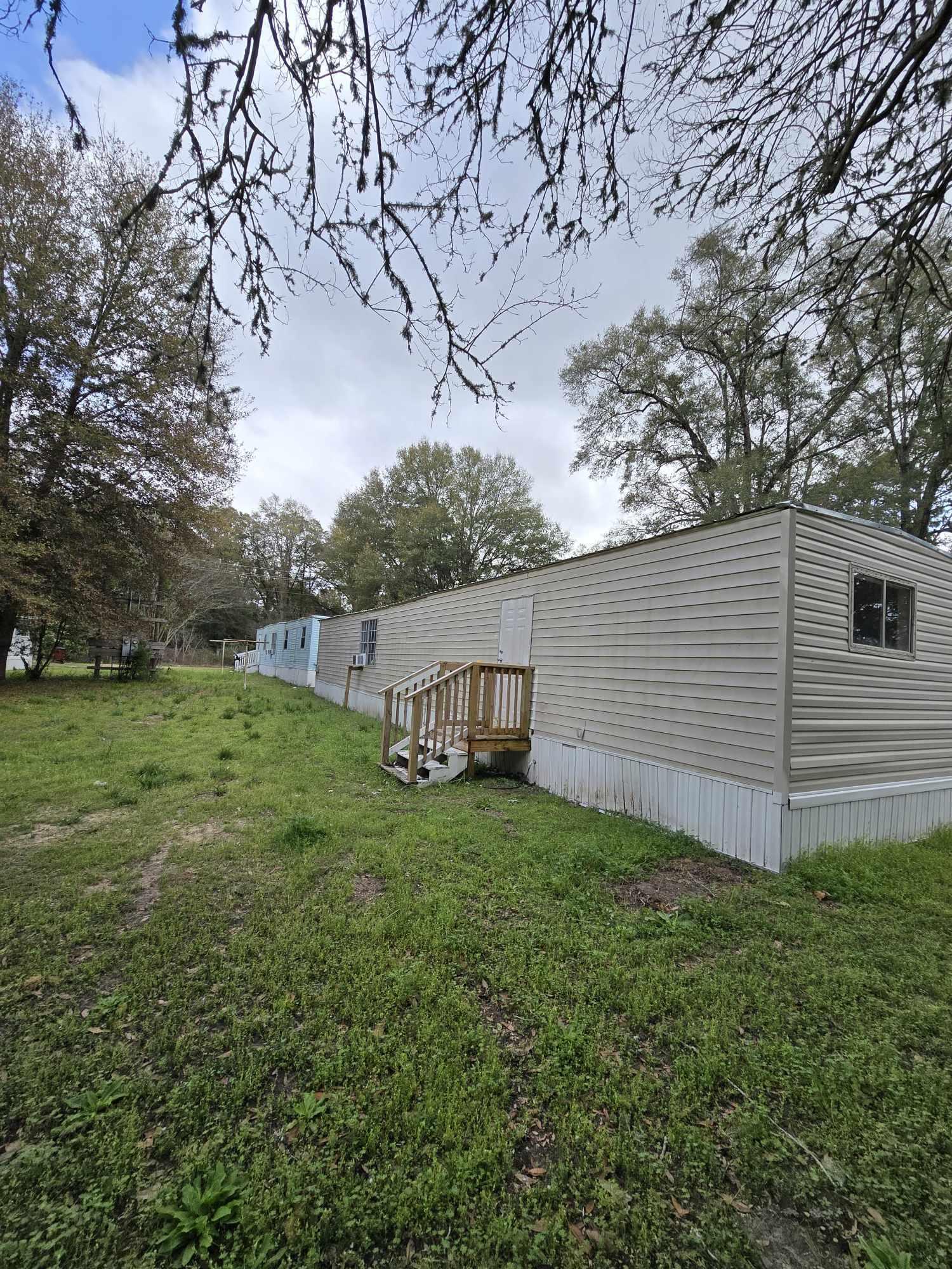 864 East Chestnut Avenue, Unit D Crestview, FL 32539 - Photo 10 of 10 a backyard of a house with lots of green space