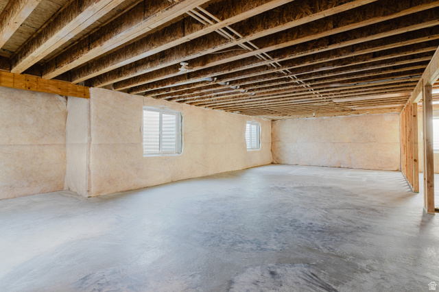 433 North 600 West Smithfield, UT 84335 - Photo 37 of 40 Spacious unfinished lower level featuring exposed joist ceiling, concrete flooring, two windows, and partial framing for future customization