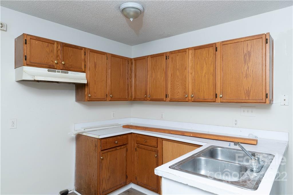 351 Haigler Street Rock Hill, SC 29732 - Photo 3 of 16 a kitchen with granite countertop a sink a cabinets and window