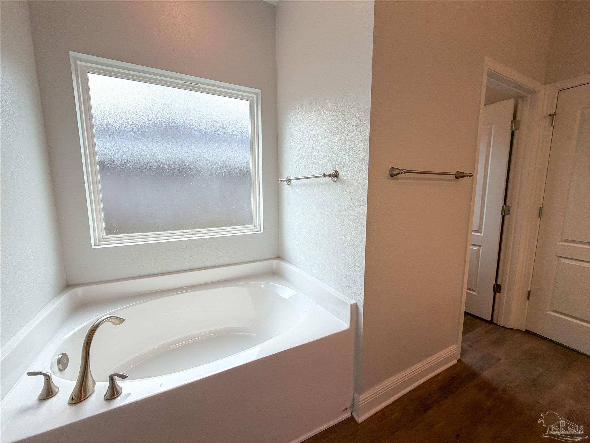 3613 Conley Drive Cantonment, FL 32533 - Photo 15 of 32 a bathroom with a tub and a shower