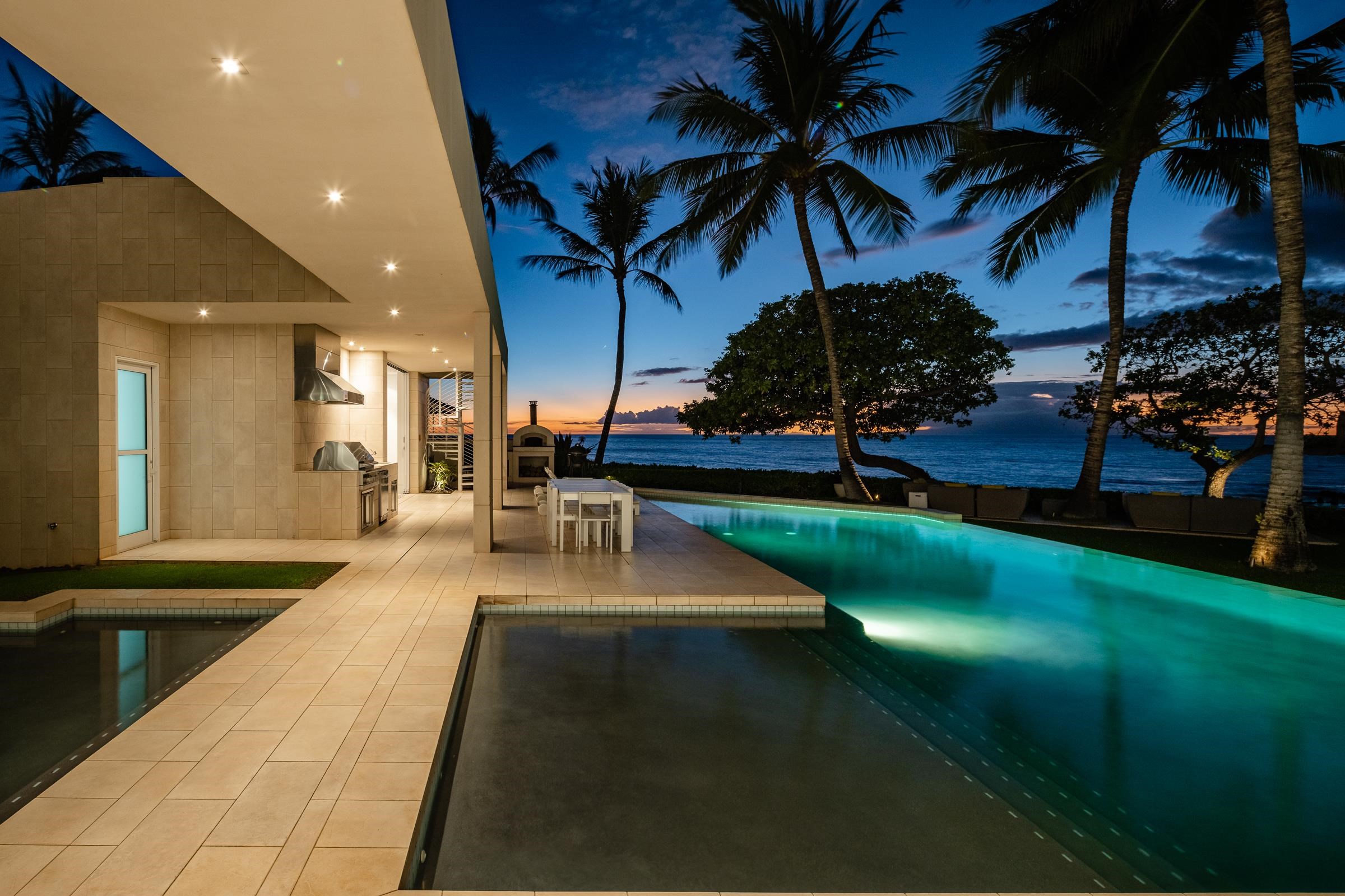4572 Makena Road Kihei, HI 96753 - Photo 13 of 30 a view of a patio with table and chairs potted plants and a large tree