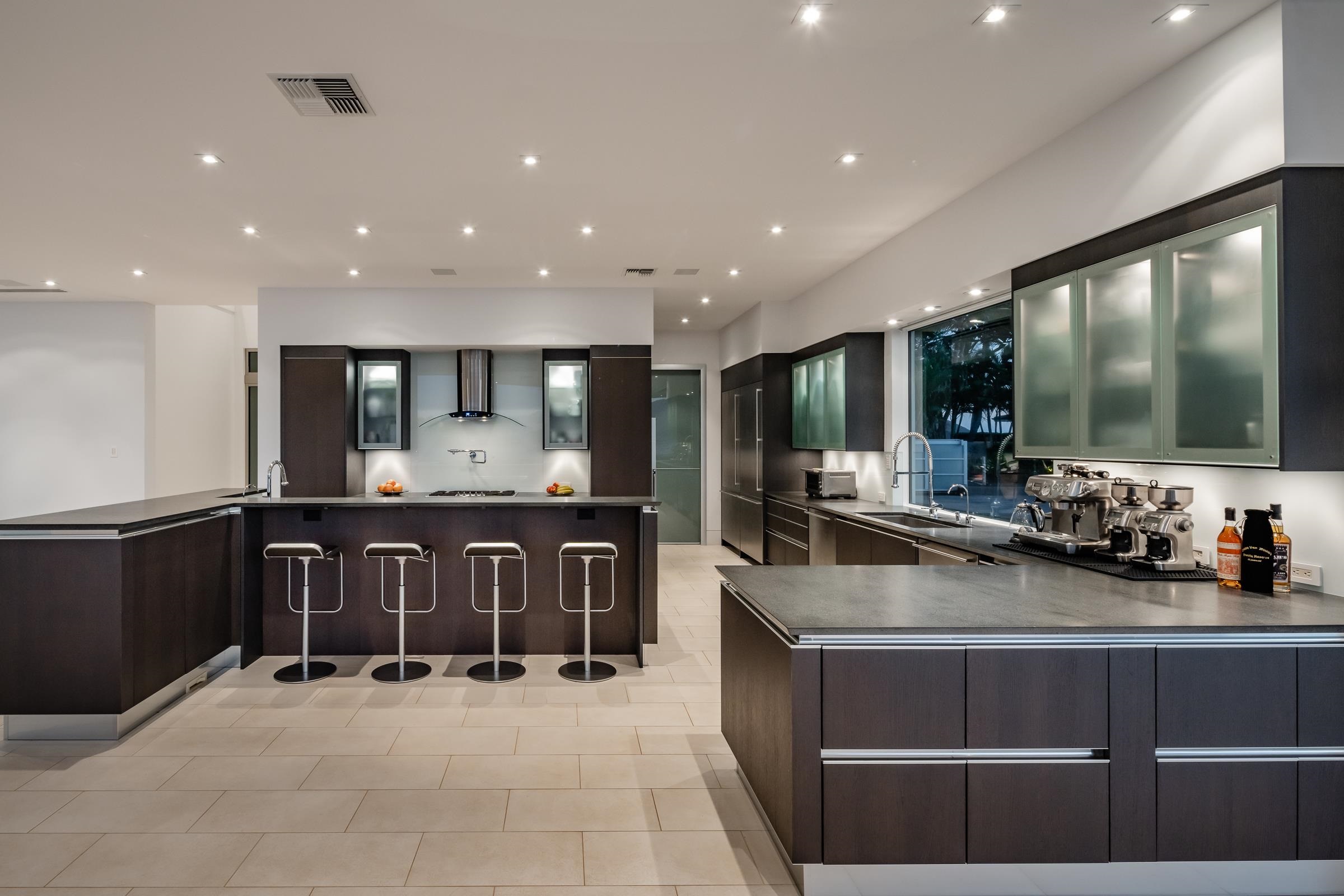 4572 Makena Road Kihei, HI 96753 - Photo 20 of 30 a large kitchen with stainless steel appliances a large counter top a stove and a sink