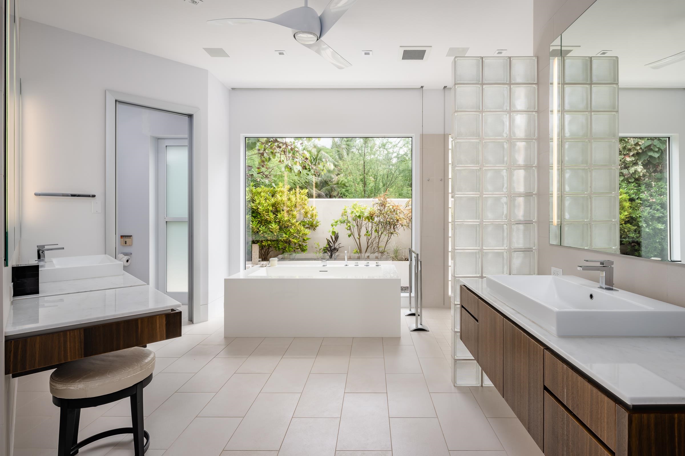 4572 Makena Road Kihei, HI 96753 - Photo 23 of 30 a bathroom with a double vanity sink a bathtub and next to a window