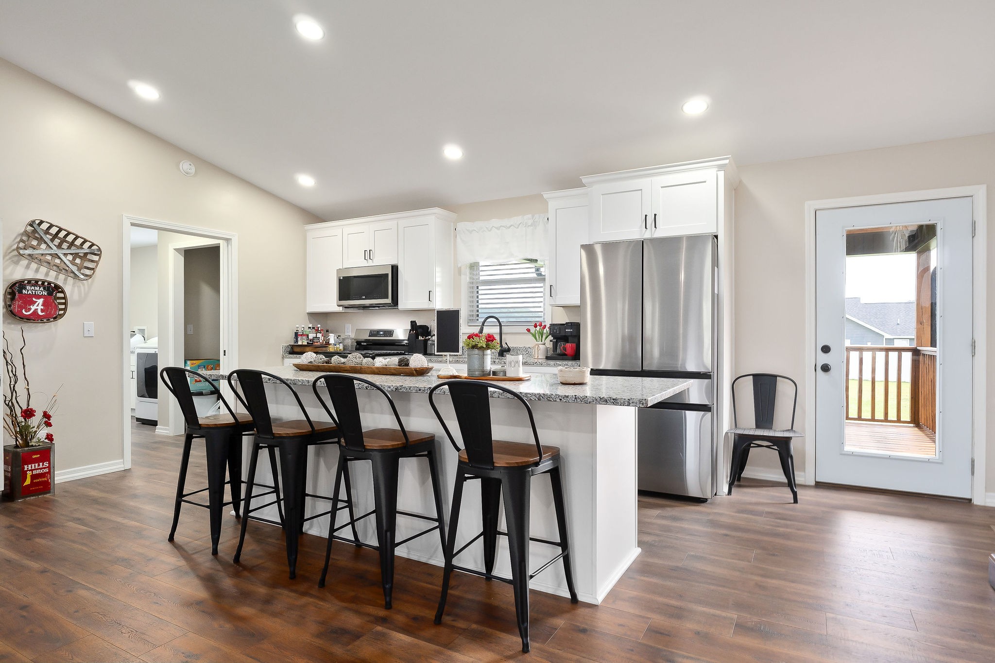 936 North Spring Street Sparta, TN 38583 - Photo 8 of 31 a kitchen with stainless steel appliances granite countertop a dining table chairs refrigerator microwave and cabinets