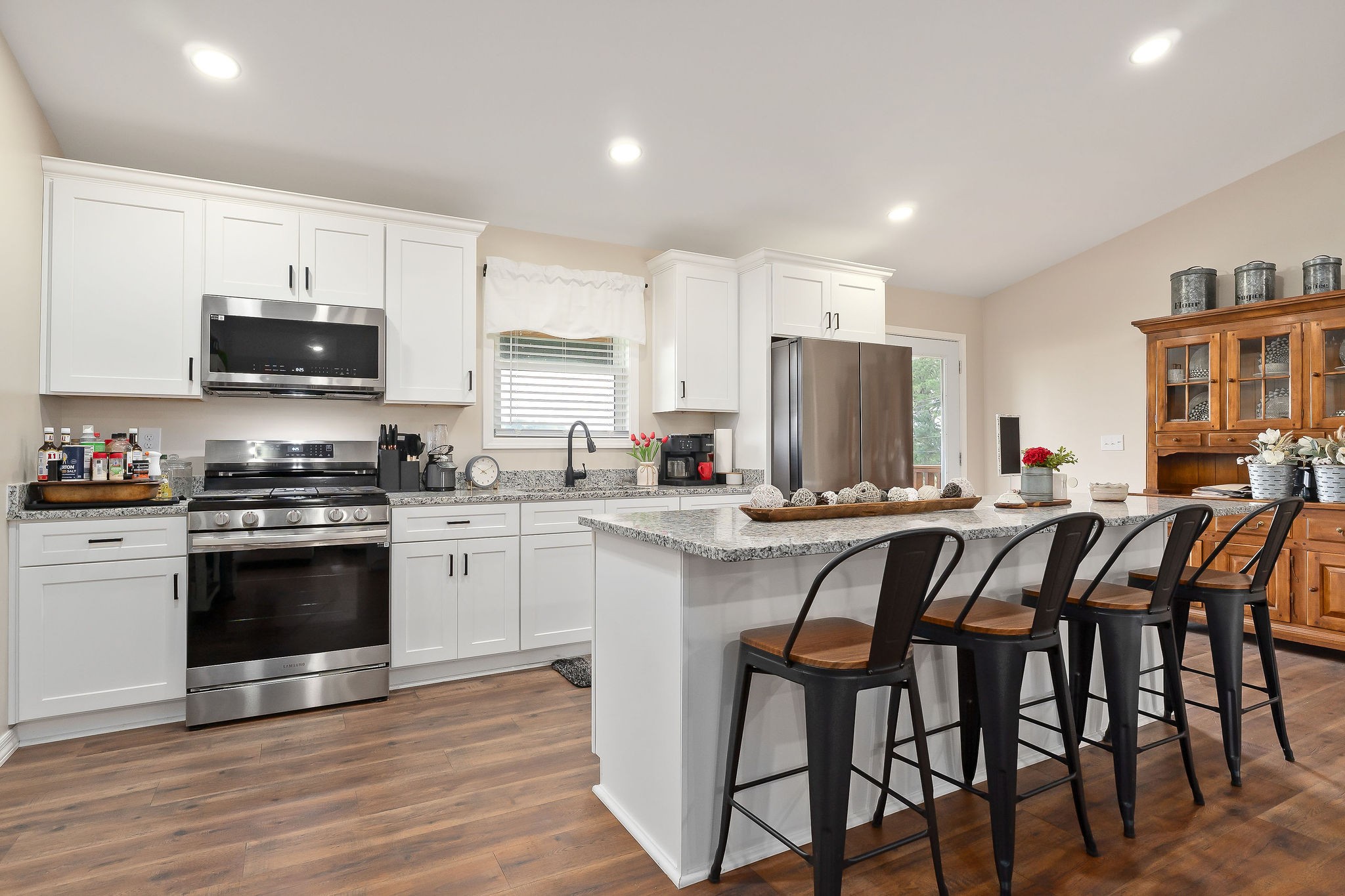 936 North Spring Street Sparta, TN 38583 - Photo 9 of 31 a kitchen with stainless steel appliances granite countertop a stove a sink a microwave a refrigerator and white cabinets